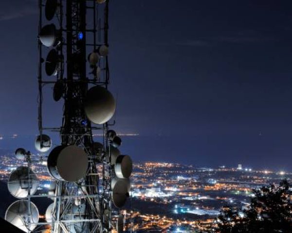 Telecommunications tower, antenna and satellite. Cellular station for smart city connect, aerial view. Big data, connection, technology concept.